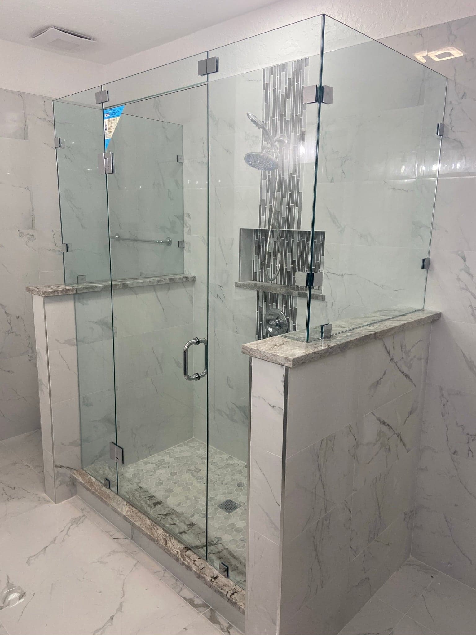 Frameless inline shower panel and door with chrome hardware